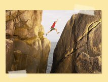 Man leaping between two rocks