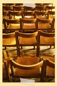 Image of rows of wooden chairs