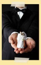 Image of man holding bride and groom cake decoration